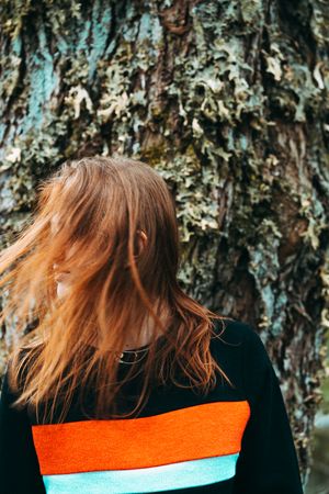 Casual redhead woman shaking with hair