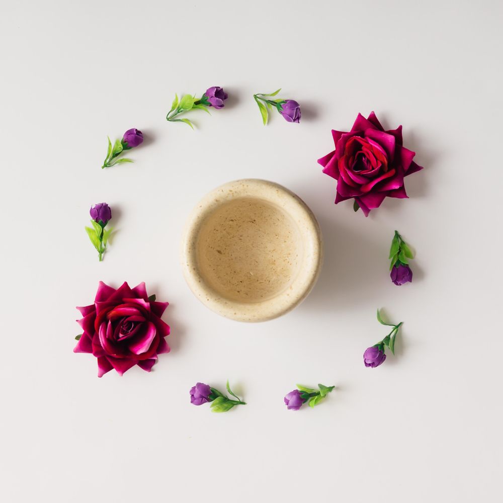 Flowers arranged in circle with coffee mug