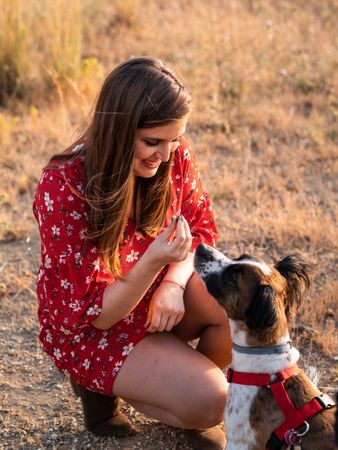 Woman with small friendly dog outdoors