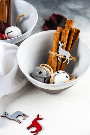 Winter table setting of cinnamon sticks in bowls with decorations