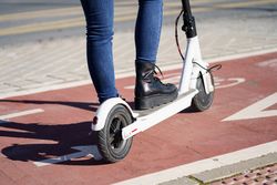Side of scooter with female driver in boots