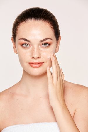 Amiable female taking care of face