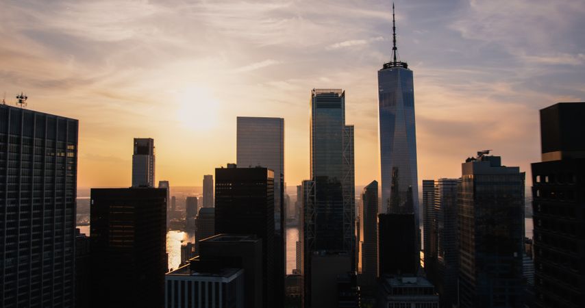 Scenic Aerial New York City Evening View of Lower Manhattan Architecture. Panoramic Downtown Photo from a Helicopter at Sunset. Cityscape with Modern Office Buildings and Historic Skyscrapers