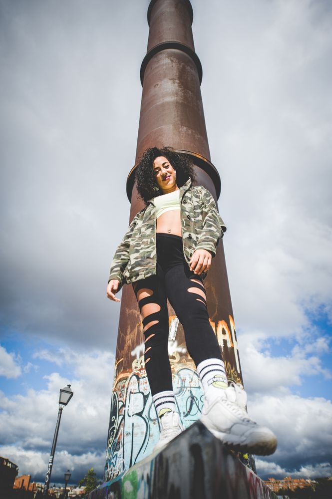 Black woman laughing in an urban environment