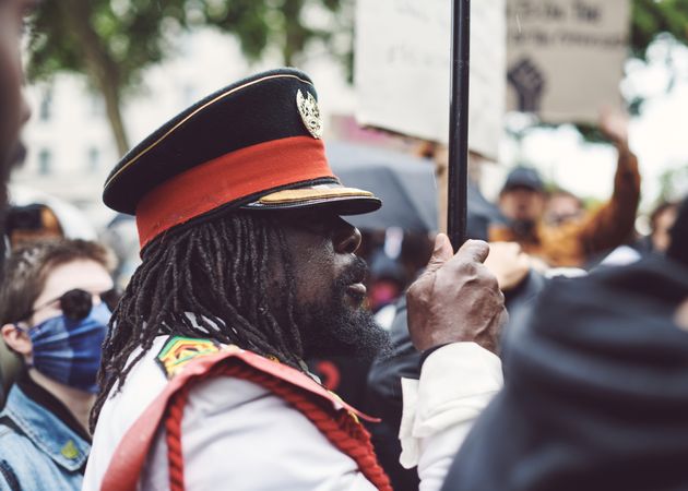 London, England, United Kingdom - June 6th, 2020: Man in military cap holding sign at BLM protest