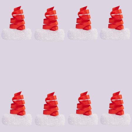 Rows of red ribbon making Santa hats