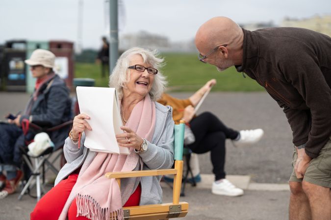 Happy older woman talking with art instructor