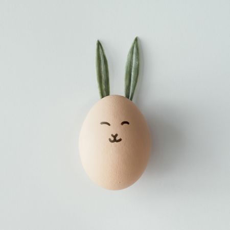 Easter egg with bunny ears and face