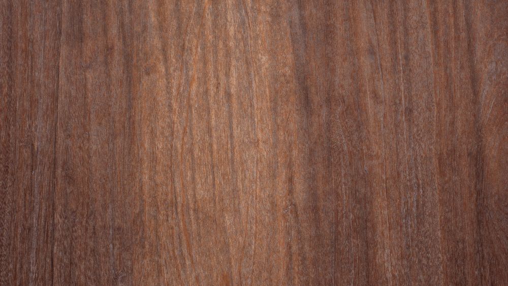 Smooth dark wood surface with fine vertical grain and warm natural tone