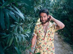 Hipster man walking in the jungle
