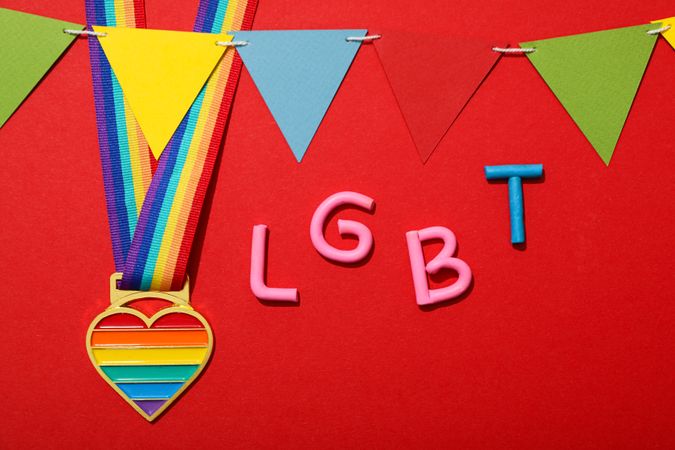 LGBT parade concept, colorful symbols on red background.