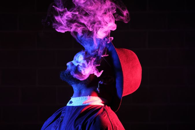 Black man with smoke in neon light