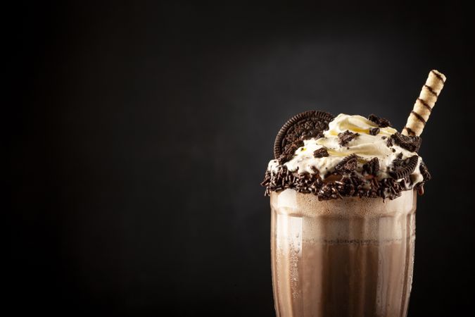 Chocolate milkshake with pieces of chocolate chip cookies.