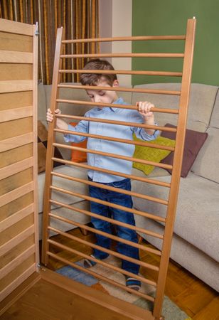 Kid assembling cot for a newborn at home