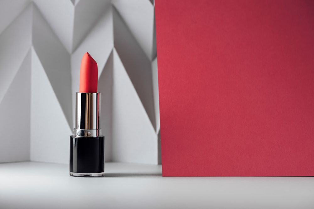 Pink lipstick on raised chevron. Product and make up contemporary concept