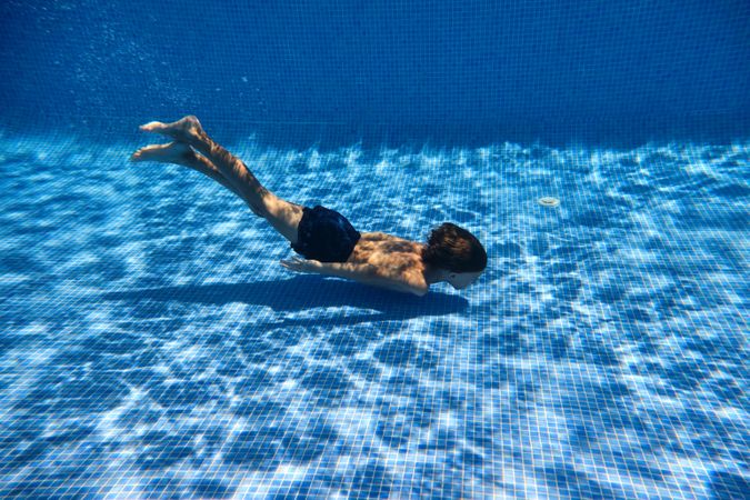 Child swimming in blue pool