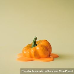Melting pumpkin on beige background beywqb
