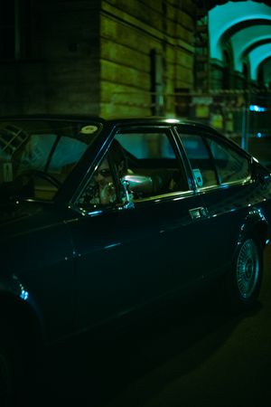 Dark retro car parked at night