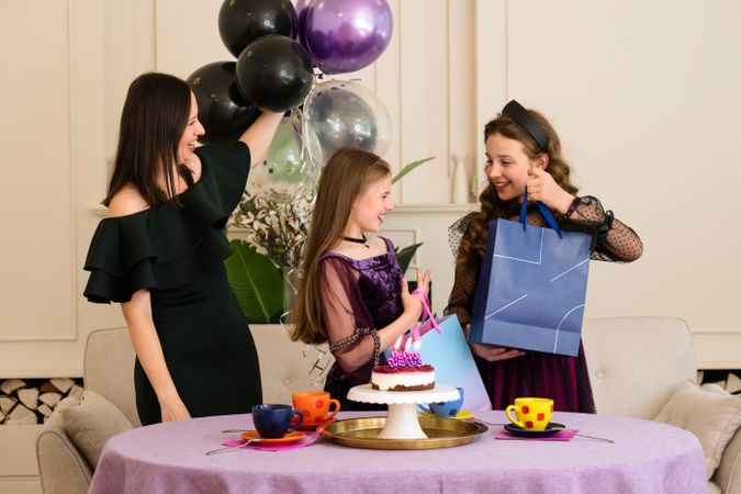 Girls receiving gifts at birthday party.