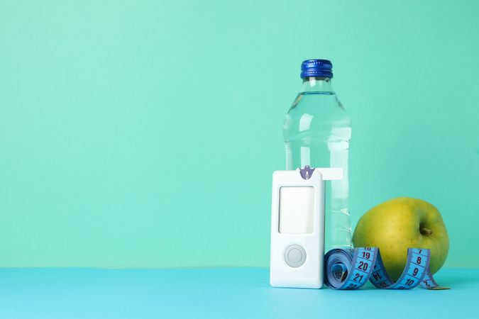 Diabetes accessories on mint background, space for text