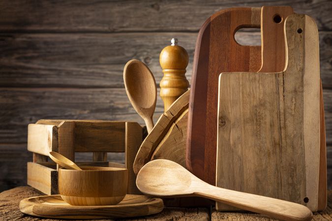 Wooden kitchen utensils on rustic background.