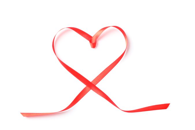 Red ribbon heart isolated on blank background