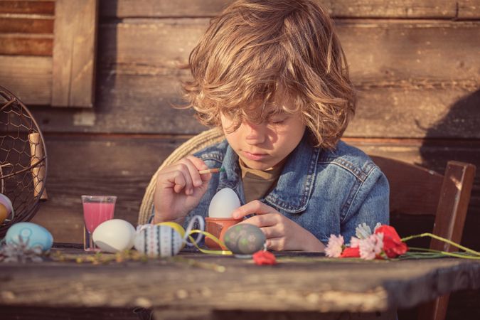 Little boy with Easter eggs and colors