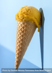 Mango ice cream in bright light, on a blue background 42pYg0