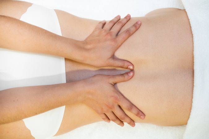 Top view of woman receiving a back massage in a spa center