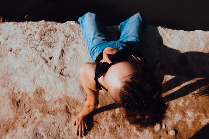 Young woman relaxing on rock