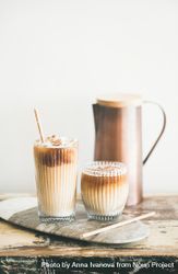 Two glasses of iced coffee with light background with pitcher 4NYqm5