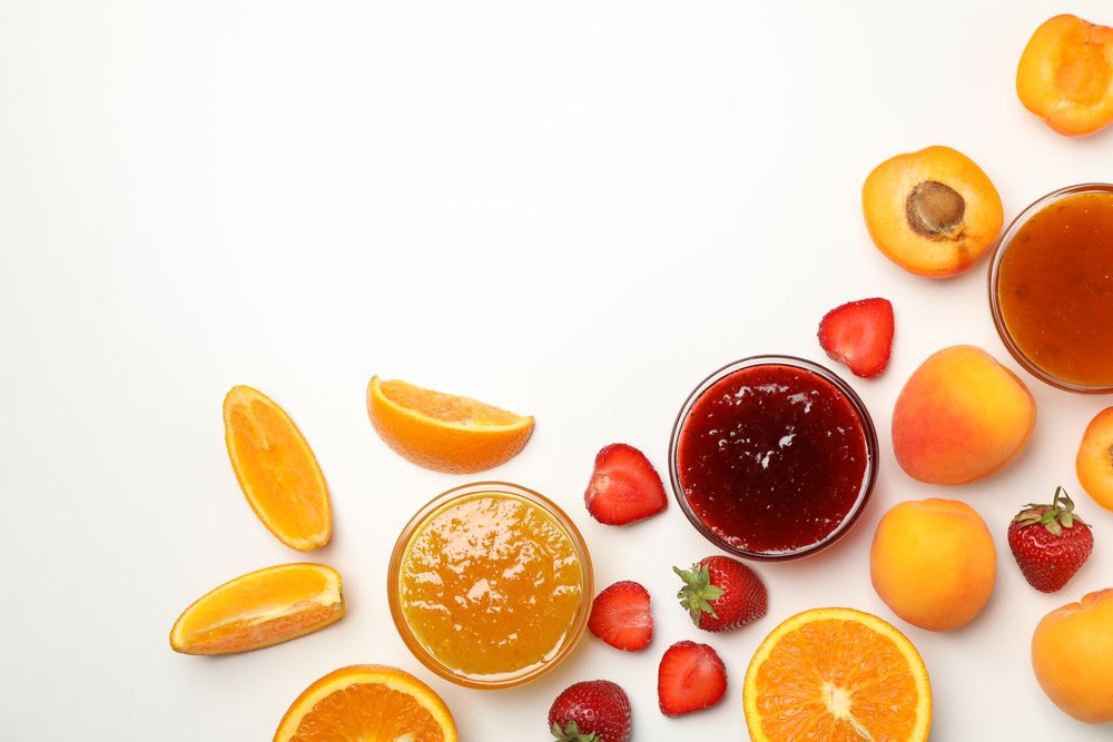 Composition with jam and ingredients on blank background, top view