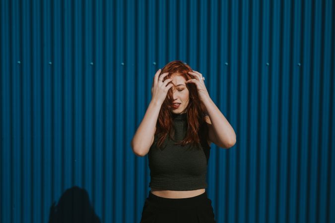 Smiling woman squinting in sun and enjoying weather