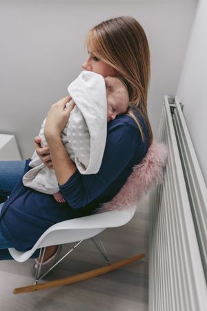 Mother hugging her sleeping baby girl