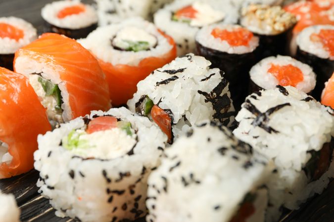 Delicious sushi rolls on wooden background, close up Japanese food
