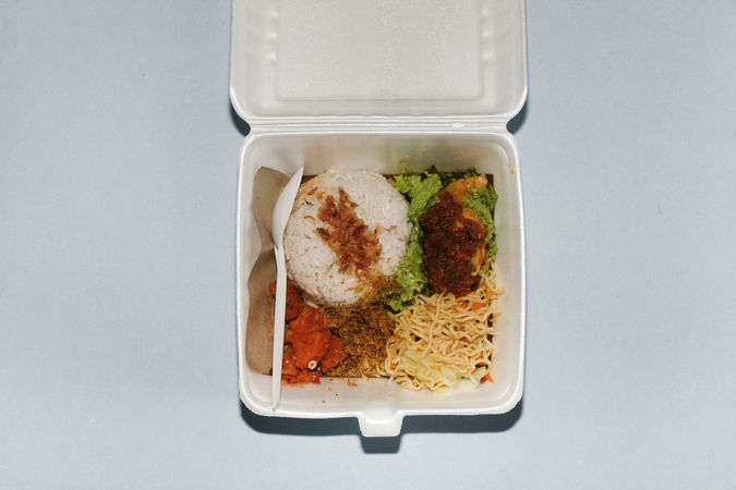 Top view of open take out box full of food