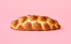 Braided bread isolated on a pink background