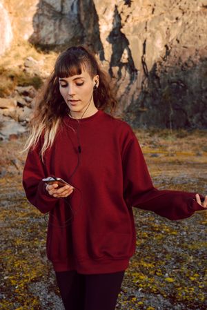 Young woman with smartphone dancing