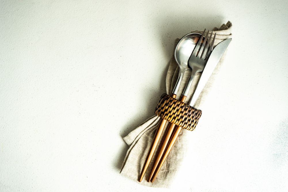 Cutlery set wrapped with napkin and ring and copy space