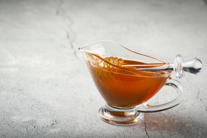 Honey in glass bowl on the table.