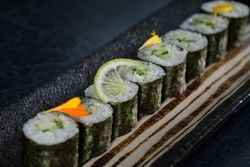 Fresh sushi rolls with lime slice and flower