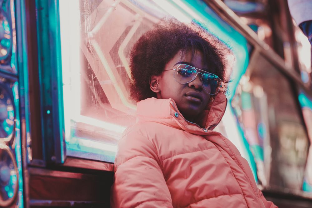 Black woman standing on night city street