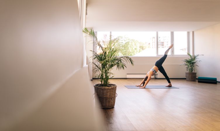 Fitness woman practising yoga indoors