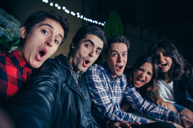 Goofy friends taking selfie at a party