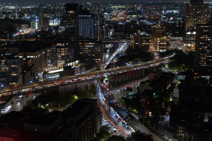 Aerial View of New York City. Helicopter Shot of a Busy Highway in New York City. Panoramic View with Traffic Around a Big City with Skyscrapers in the Background