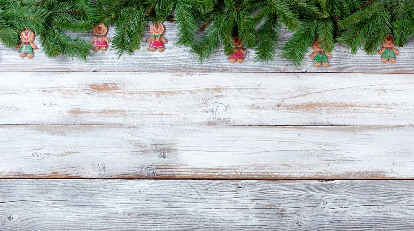 Christmas evergreen branches and cookies on vintage wooden planks