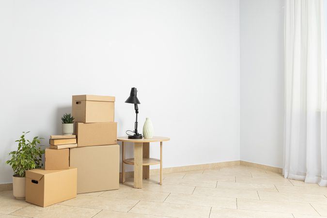 Stacked things in an empty room, moving concept