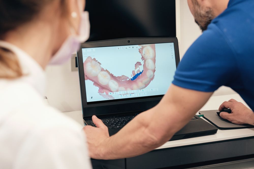 Unrecognizable dentists examining 3D teeth scan