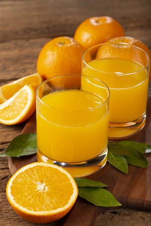 Glass with orange juice on the table.
