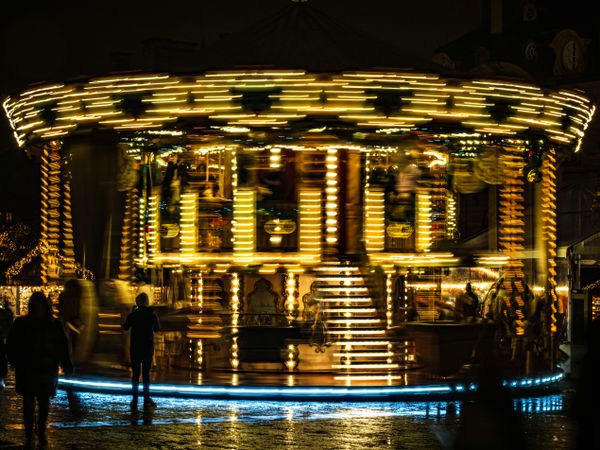 Merry go round spinning at night in Market